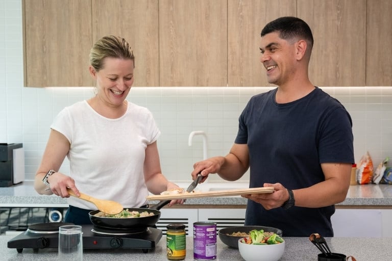 Happy couple cooking a healthy meal in the kitchen together