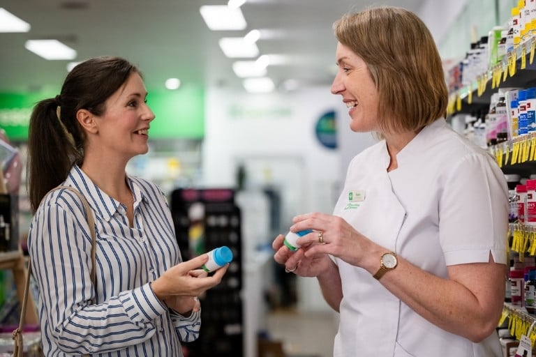 Female pharmacist discussing supplements with a female customer in the pharmacy store