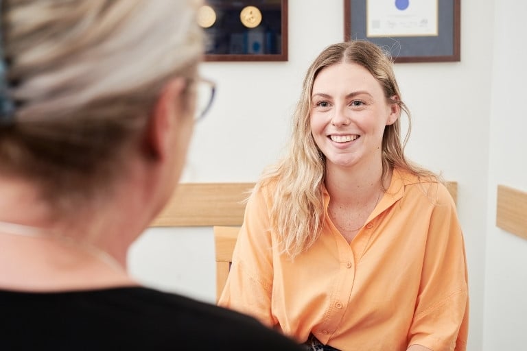 Female patient discussing sexual health check and cervical screening with female GP in consulting room