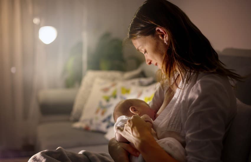 Woman breastfeeding at home