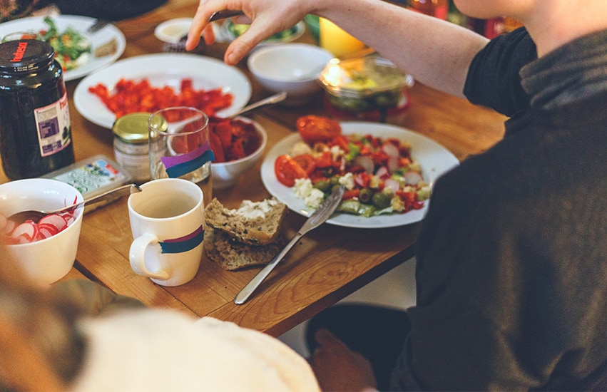 Family at dining table eating a meal