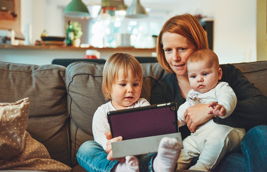 Woman with children on ipad