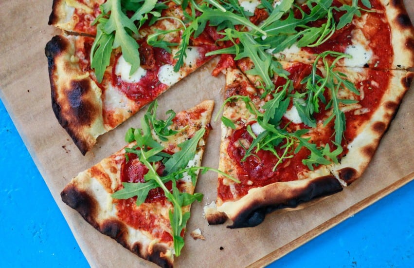 Pizza with cheese tomato and rocket