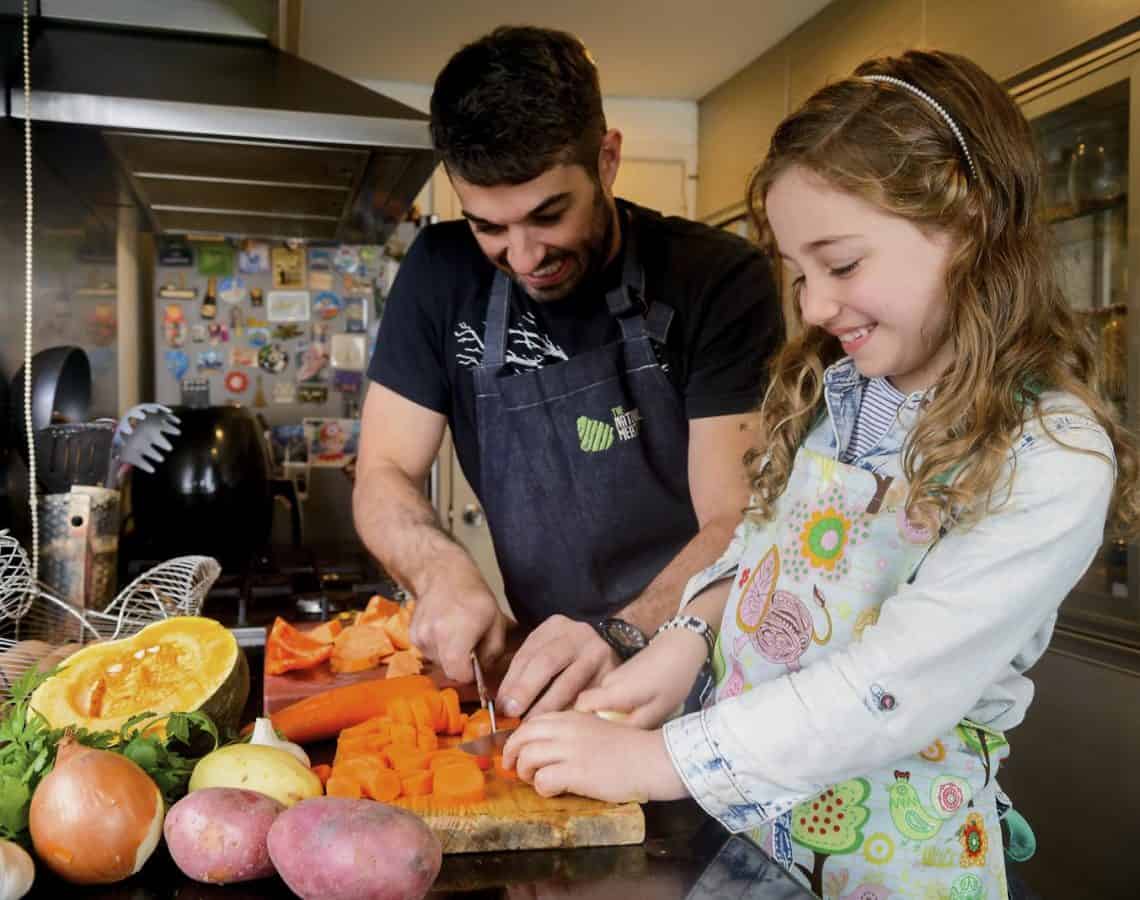 Father and daughter preparing food; World Health Organization