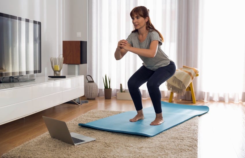 woman exercising in lounge room