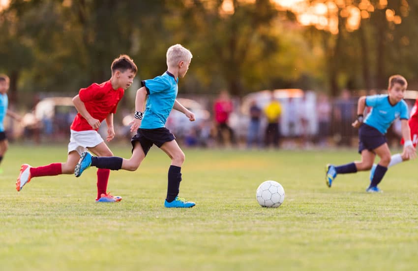 Boys playing soccer on a soccer field