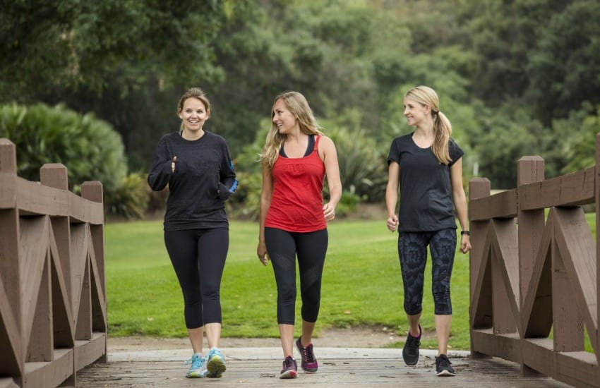 Women walking across bridge