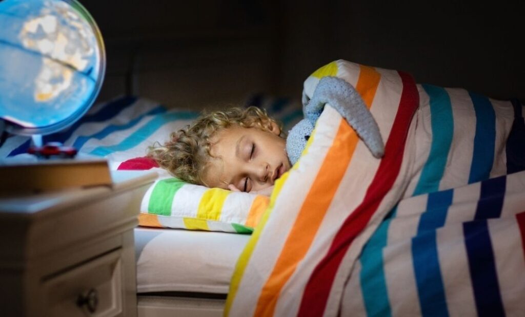 Child asleep in their bed