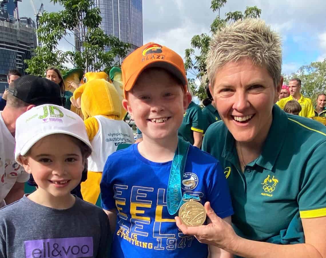 Olympian Natalie Cook OAM OLY is pictured with local kids, Oscar and Isla at the Green and Gold Runway event