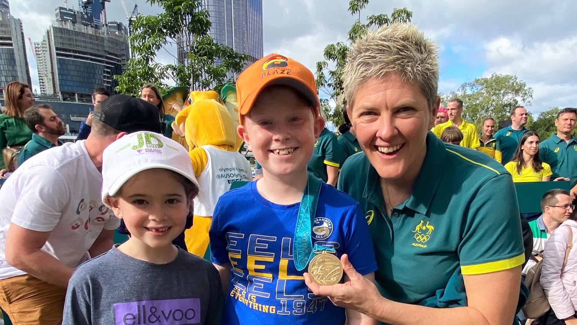Olympian Natalie Cook OAM OLY is pictured with local kids, Oscar and Isla at the Green and Gold Runway event