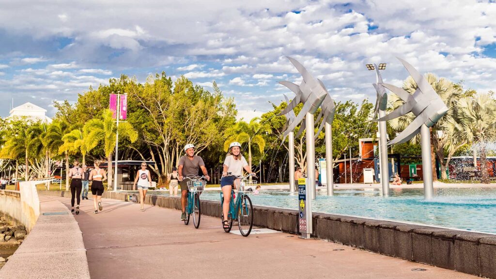 People walking and bike riding along an exercise path in Cairns.