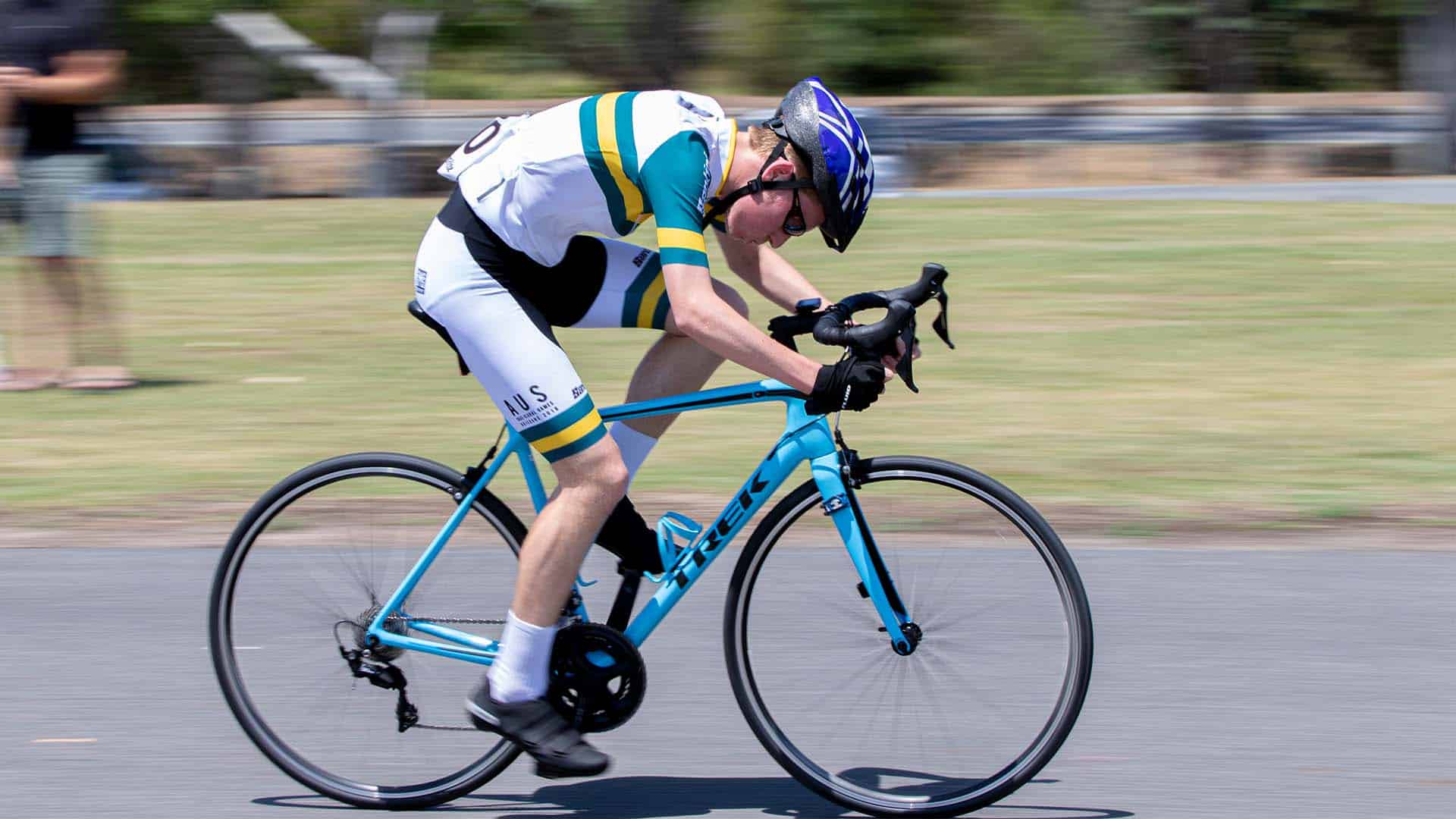 A man riding a bike at high speed in cycling gear