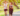 Two young women running along a path in a park