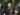 3 members of the Queensland Symphony Orchestra are standing outside holding brass instruments
