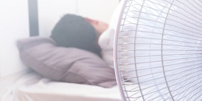 A Man Sleeping On the Bed And Turn On The fan