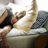 Young caucasian boy sleeping in bed