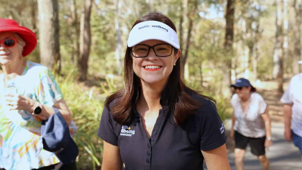 Dr Robyn Littlewood wearing a Health and Wellbeing Queensland hat and shirt