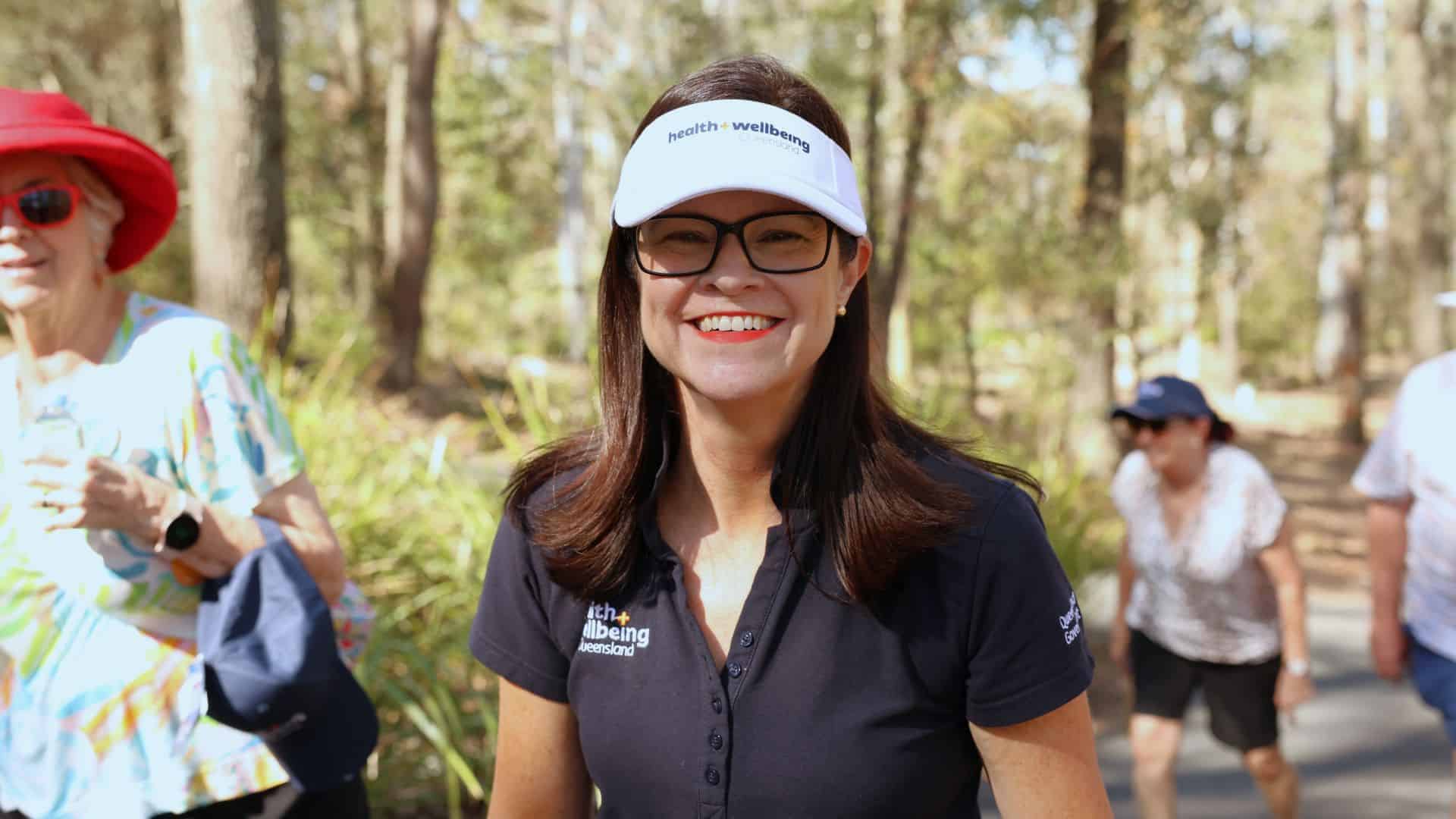 Dr Robyn Littlewood wearing a Health and Wellbeing Queensland hat and shirt