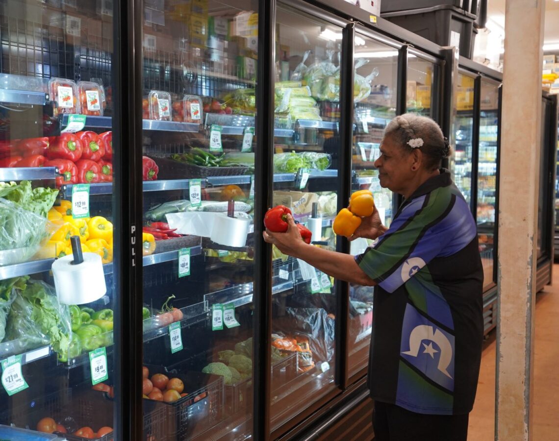 A person stocking fresh produce in a regional store