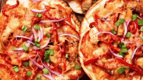 BBQ chicken pizza with sliced capsicum and red onion