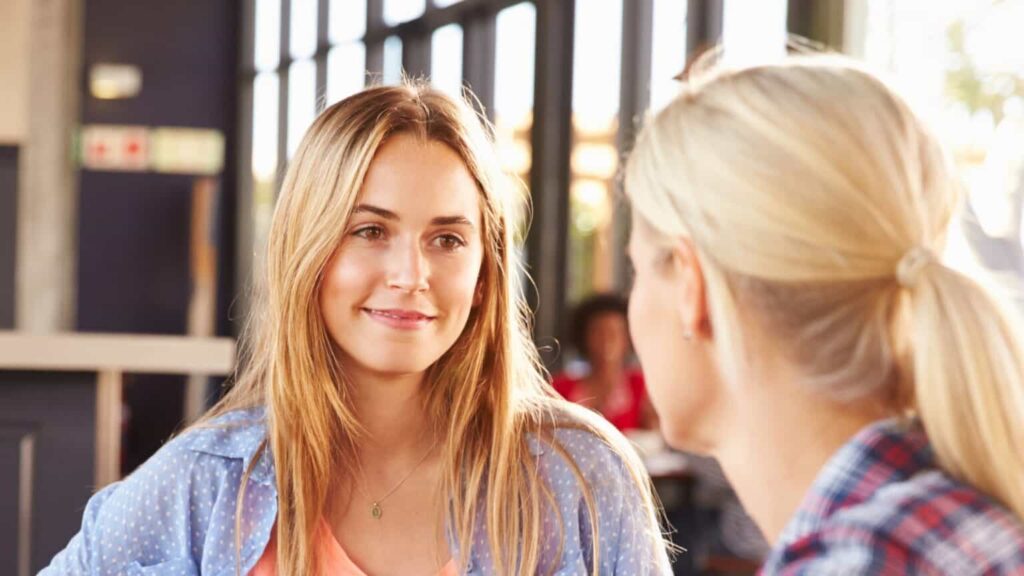 Close up of two women talking at a cafe