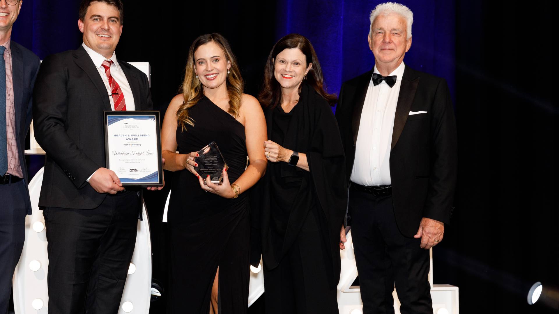 Representatives from Wickham Freight Lines accept The Health and Wellbeing Award at the Queensland Trucking Association Road Freight Industry Awards 2024
