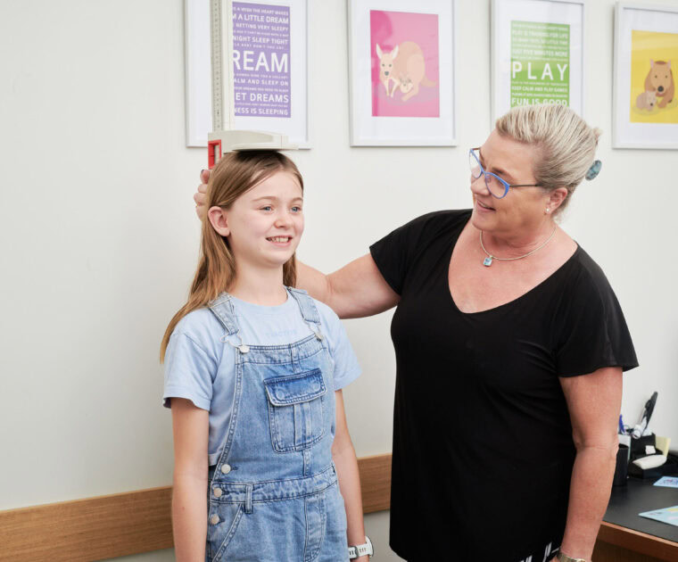Clinician measuring height of young child