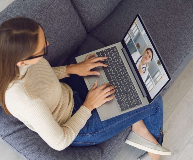 Woman watching health professional on laptop