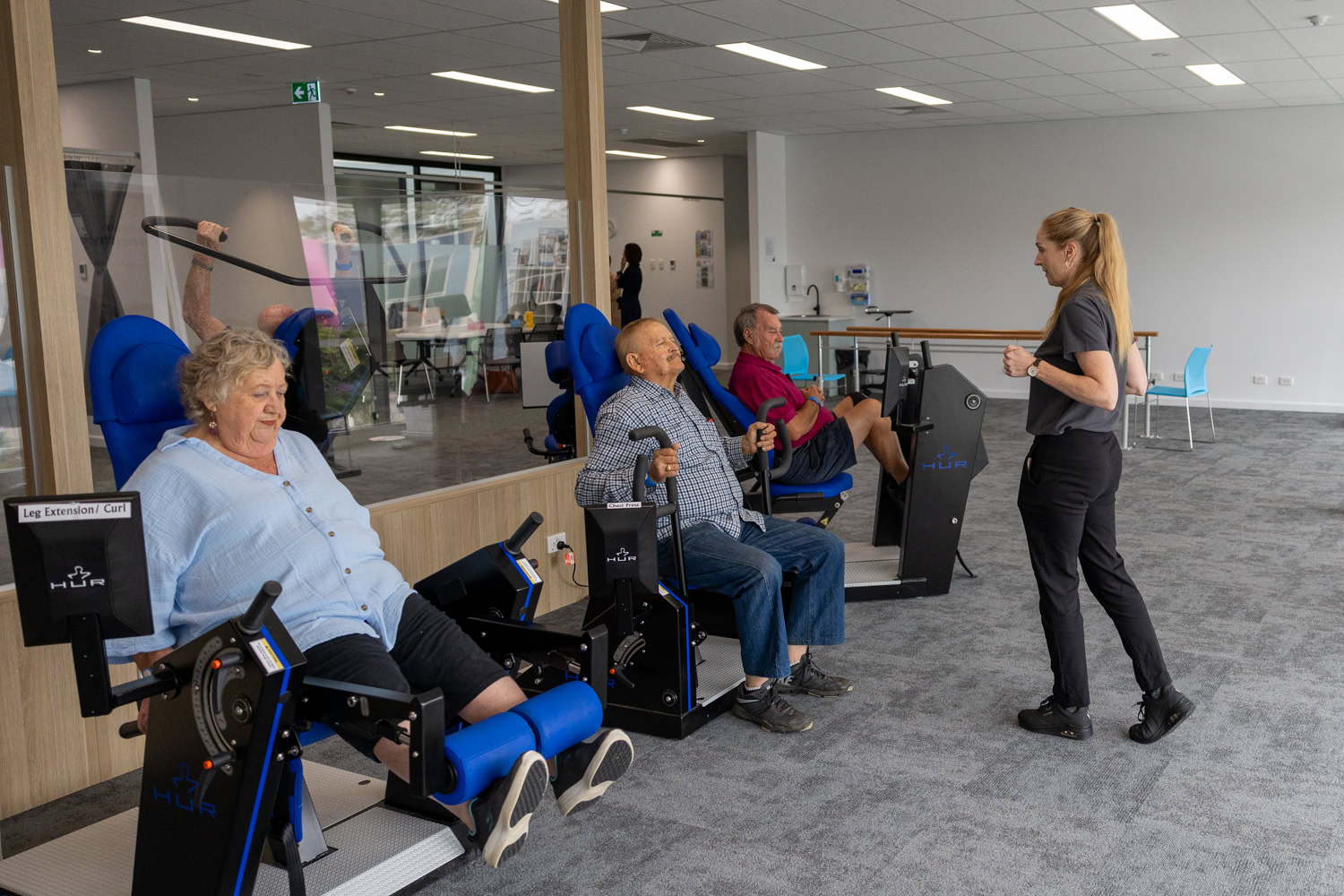 People using seated exercise machines at Logan Healthy Living