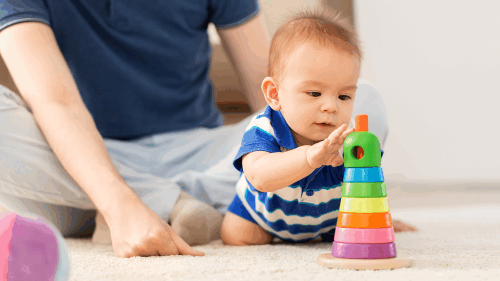 Baby playing with colourful stacking toy