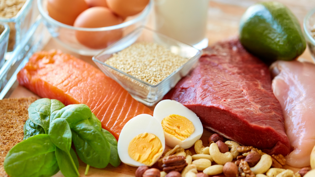 Salmon, eggs, red meat, avocado and nuts on a plate