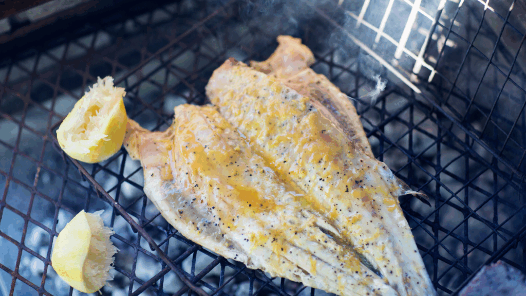 White fish and lemon on a bbq