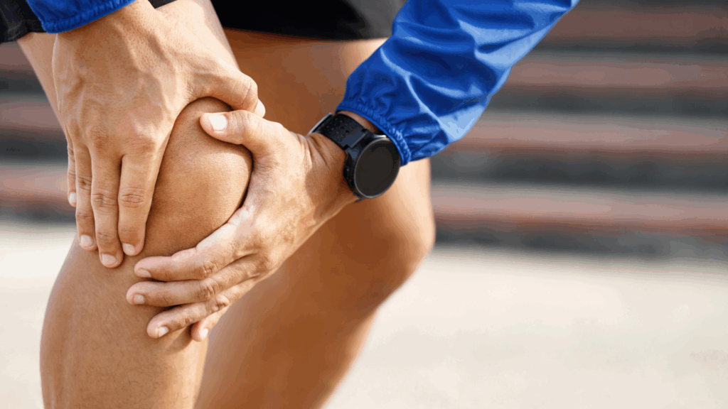 A close up shot of a person holding their knee