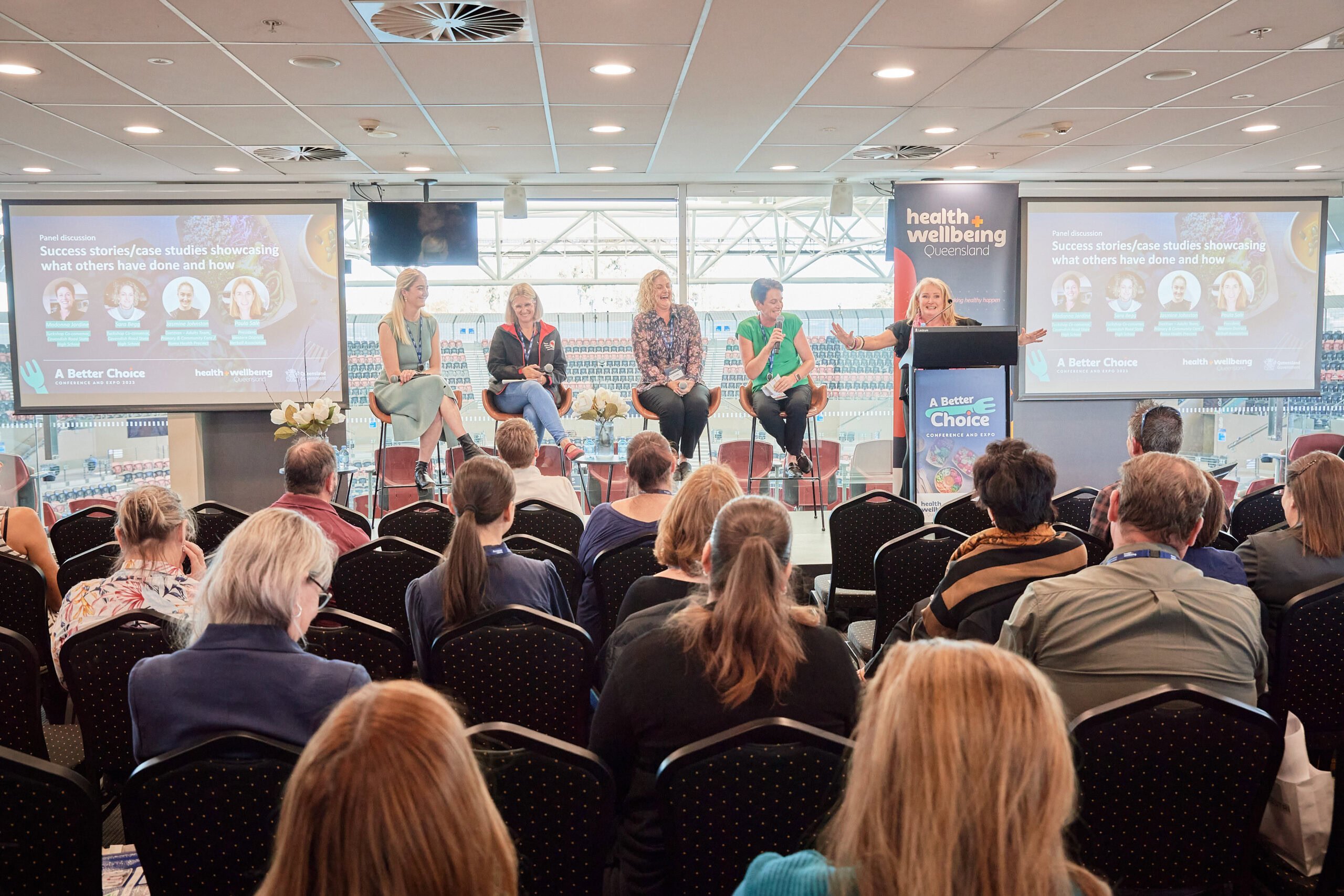 A group of people watching a panel talk on stage at the ABC conference 2023
