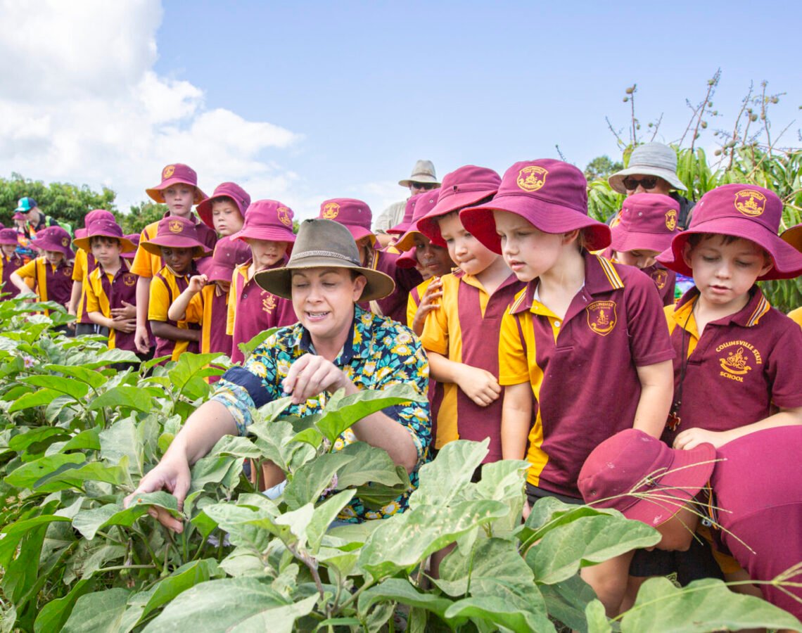 A group of school kids visiting a farm