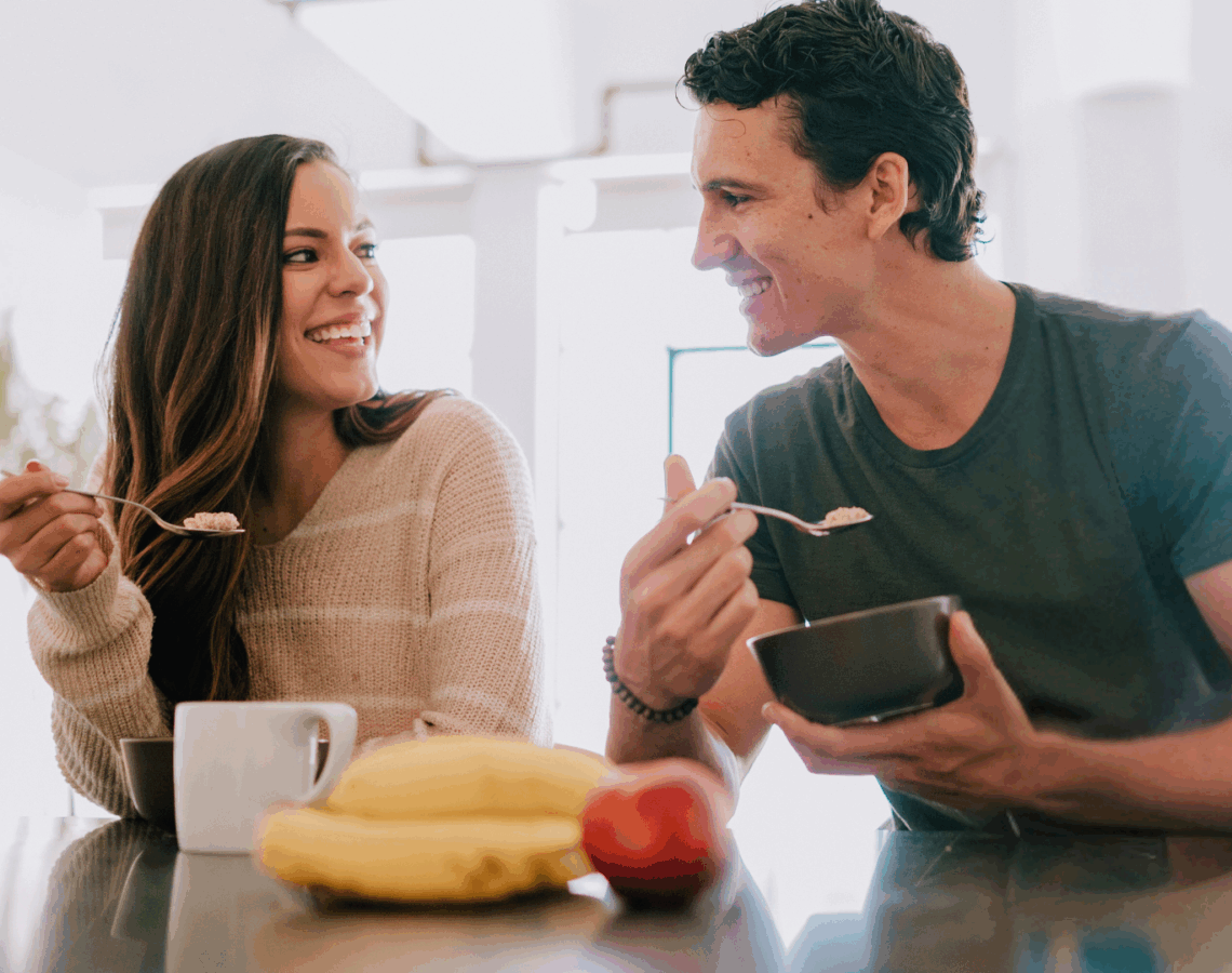 A couple eating breakfast together