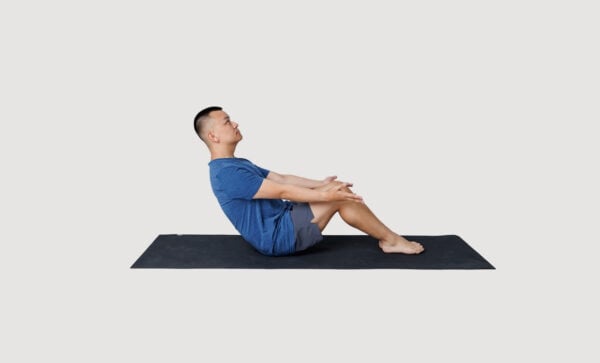 Boat pose variation with feet on ground