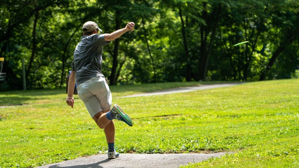 Young man throwing a frisbee.