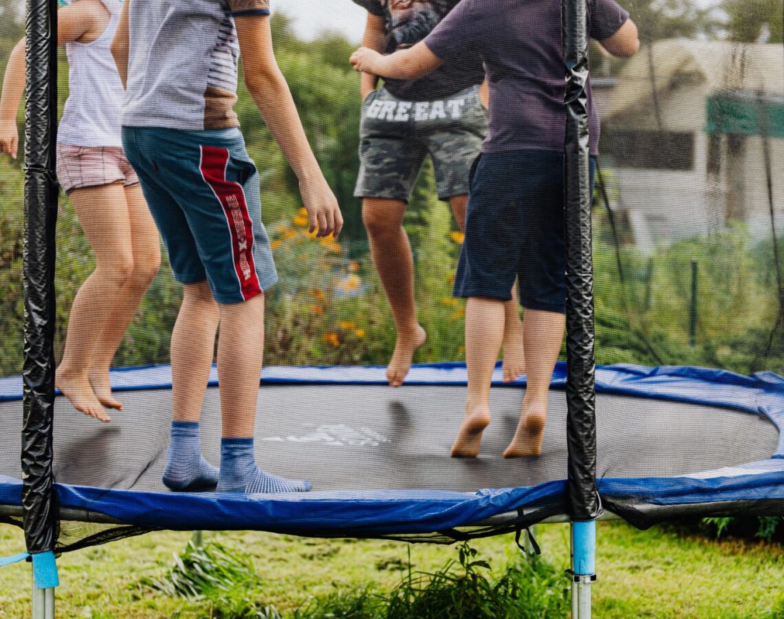 4 kids bounce on a trampoline