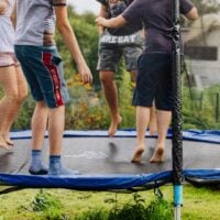 4 kids bounce on a trampoline