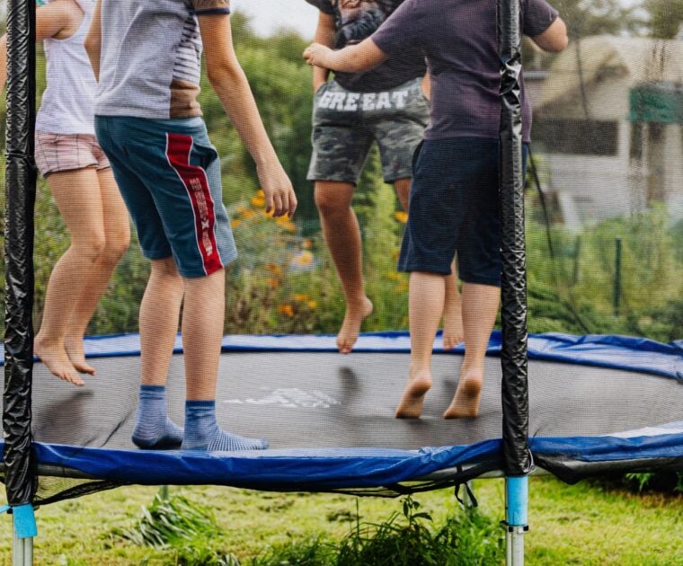 4 kids bounce on a trampoline