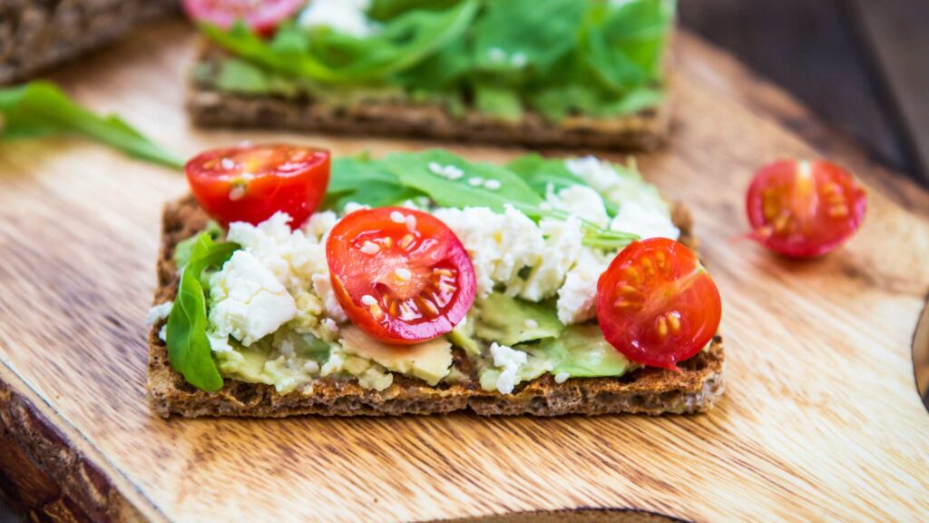 Wholegrain cracker with sliced cherry tomatoes and goats cheese