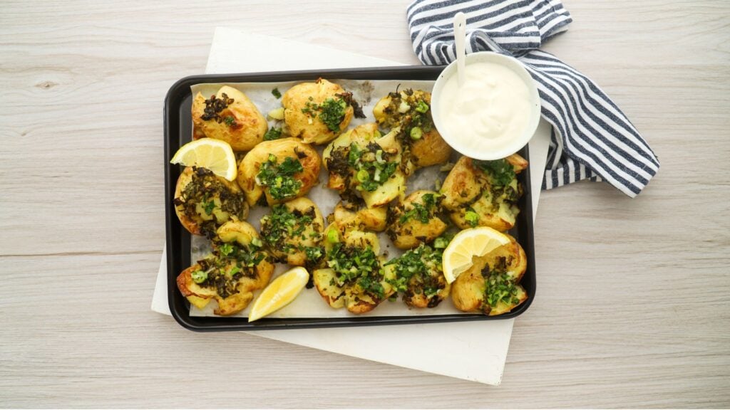 Crispy smashed potatoes with herb salsa