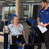 Maureen Trainor using gym equipment with instructor