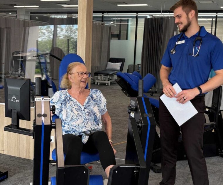 Maureen Trainor using gym equipment with instructor