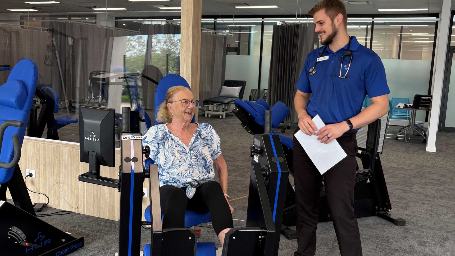Maureen Trainor using gym equipment with instructor