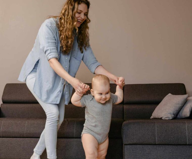 Baby learning to walk with parent