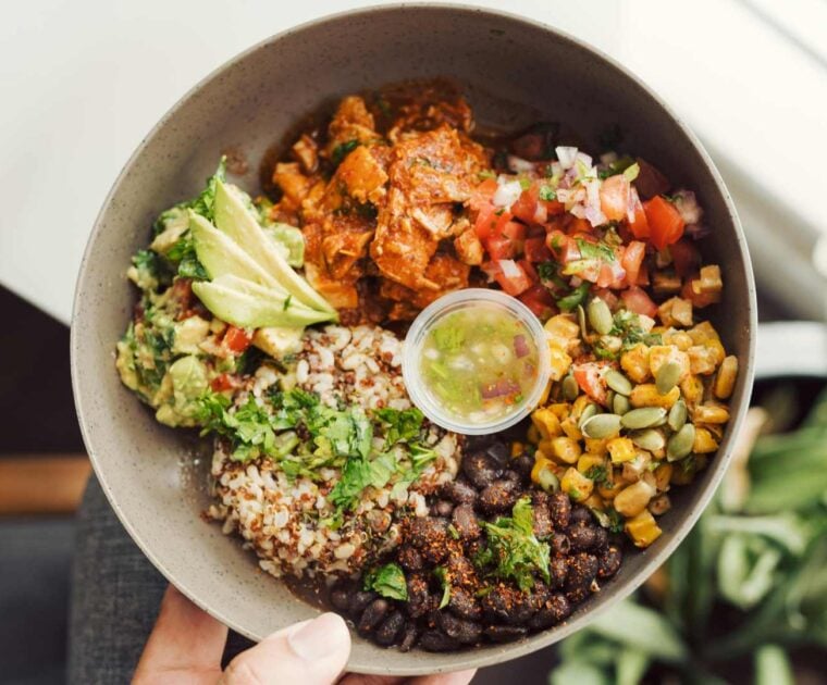 A salad bowl featuring fresh salad and protein