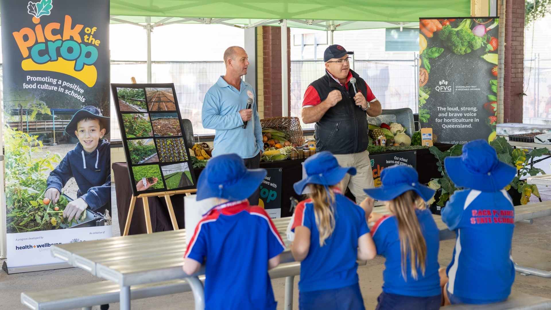 Farmer talks to school children at event