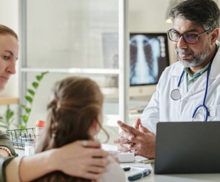 Health professional talking with parent and child